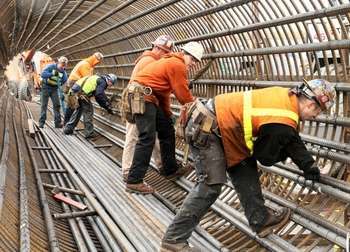 Steel workers forming a rebar cage